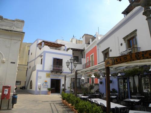 a street with white buildings and tables and chairs at Case Vacanze Albamarina in Lipari