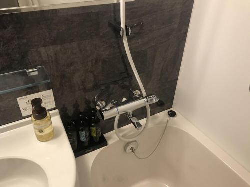 a bathroom with a white toilet with a bottle on it at Sunrise Choshi in Choshi