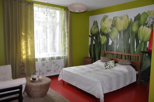 a bedroom with a bed with a flower mural on the wall at SuperiQ Villa Sopot in Sopot