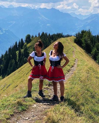 two girls are standing on top of a hill at Balmers Hostel in Interlaken