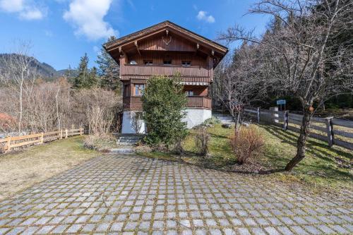a wooden house with a stone path in front of it at Haus Löweneck in Bayrischzell