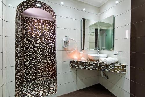 a bathroom with a sink and a mirror at Gianna Suites in Fira