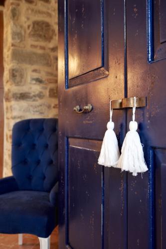 a door with tassels on it with a blue chair at Podere di Moiata in Campestri