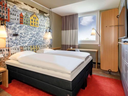 מיטה או מיטות בחדר ב-ibis Landshut City