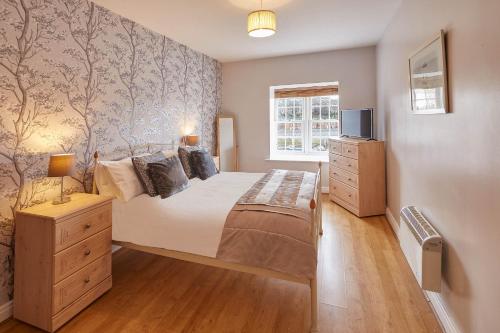 a bedroom with a large bed and a window at Host & Stay - Seal Watch in Whitby