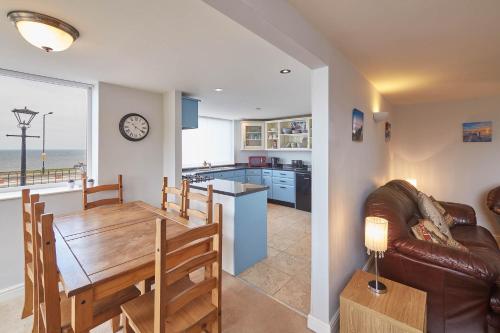a kitchen and living room with a table and a dining room at Host & Stay - Sunset View in Whitby