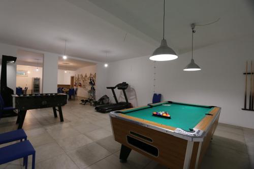 a living room with a pool table and a room with a pool table at Apartments Sucic Iva i Tea in Soline