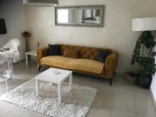 a living room with a couch and a table at Captain Emo City Apartments in Pula