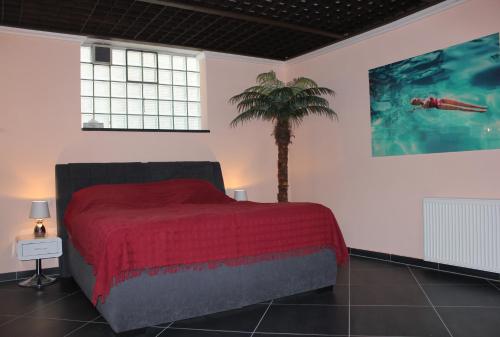 a bedroom with a bed with a palm tree in it at BLUE SKY-Suite in Fellbach