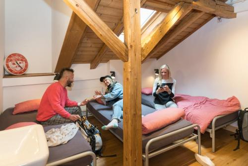 two people are sleeping in a bunk bed at Balmers Hostel in Interlaken