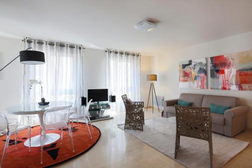 a living room with a table and a couch at Cosy and large flat in the hypercentre of Avignon Provence - Welkeys in Avignon