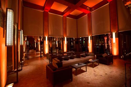 a lobby with couches and tables in a building at Amanjena Resort in Marrakech