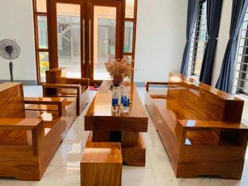 a living room with wooden benches and tables at Khách sạn ĐẢO LÝ SƠN- AN DUYÊN in Quang Ngai