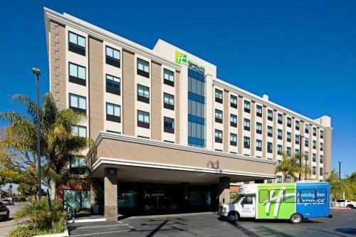 a large hotel with a truck parked in front of it at Holiday Inn Express Los Angeles LAX Airport by IHG in Los Angeles