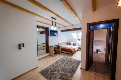 a living room with a bedroom and a bed at Cabana Parang in Ranca