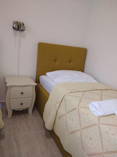 a bedroom with a bed and a side table at Hotel Florentina in Constanţa