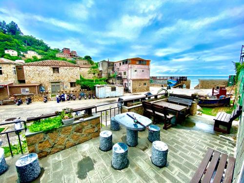 a balcony with benches and a view of the ocean at Jin Sha Ting Hai Homestay I in Nangan