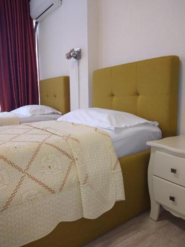 a bedroom with two twin beds and a lamp at Hotel Florentina in Constanţa