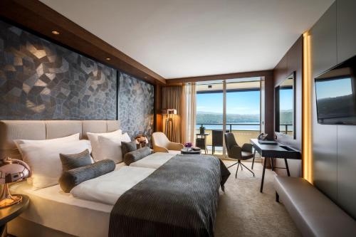 a hotel room with a bed and a desk at Hotel Ambasador - Liburnia in Opatija