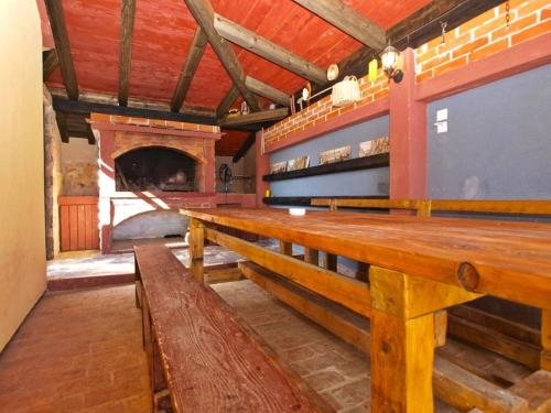 a large room with wooden benches and a fireplace at Holiday Home Mario in Pula