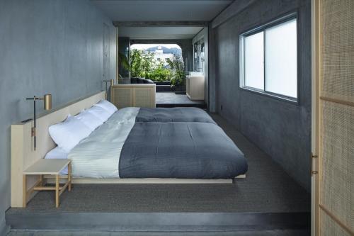 a bedroom with a large bed and a window at hotel sou #sou in Goto