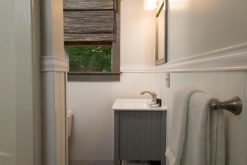 a bathroom with a sink and a window at Lake Bomoseen Lodge in Bomoseen