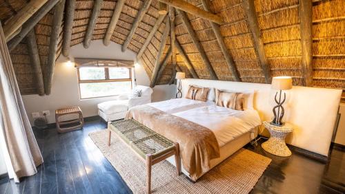 a bedroom with a large bed in a attic at Gondwana Game Reserve in Kleinberg