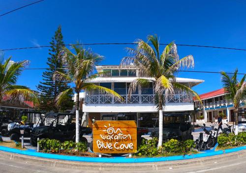 a building with a blue cave sign in front of it at Hotel Blue Cove by On vacation in San Andrés