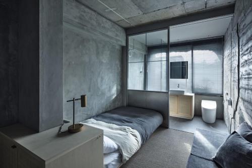 a bedroom with a bed and a large window at hotel sou #sou in Goto