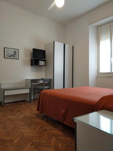 a hotel room with a bed and a refrigerator at Affittacamere Giannina in Alassio
