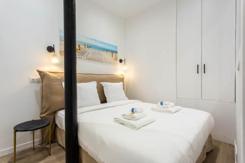 a bedroom with a bed with two towels on it at CMG Saint Louis- Vaucouleurs in Paris