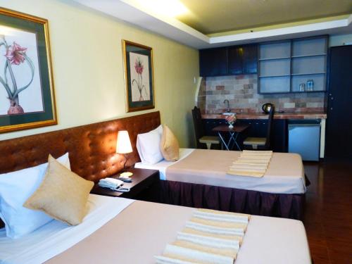 Postel nebo postele na pokoji v ubytování Silver Oaks Suites & Hotel