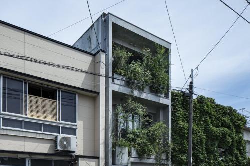 a building with plants on the side of it at hotel sou #sou in Goto