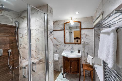 a bathroom with a sink, toilet and bathtub at Residence U Černého Orla in Prague