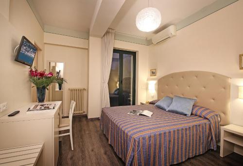 Säng eller sängar i ett rum på Hotel Panoramica