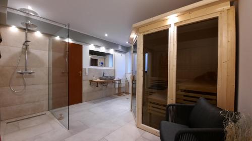 a bathroom with a shower and a glass shower stall at Villa Rose in Altenau