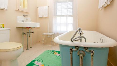 a bathroom with a tub and a toilet and a sink at Captain Morse House - Luxury, Waterfront, Town, & Beaches - 5 stars in Edgartown