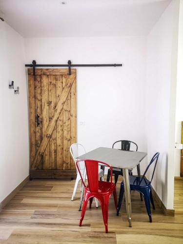 a table and chairs in a room with a wooden door at La Casetta in La Spezia
