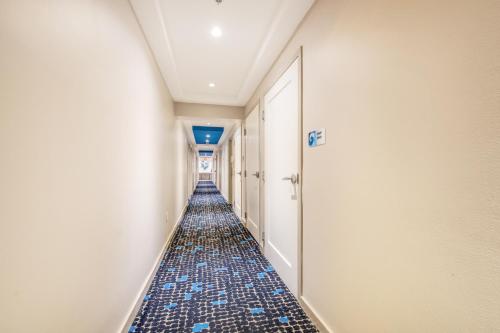 an empty hallway with blue tiles on the floor at The Landon Bay Harbor-Miami Beach in Miami Beach
