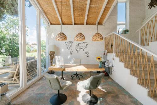 a home office with a wooden table and chairs at Friends Boutique Hotel in Lozenets
