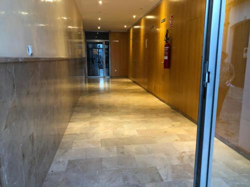 a hallway in a building with a tile floor at Apartamento Sorolla Center in Ayamonte