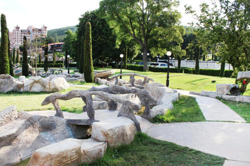 a statue in a park with rocks and trees at Royal Bay Hotel - All Inclusive in Elenite
