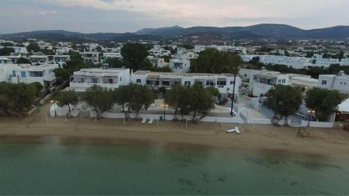 a city with white buildings and a body of water at Ostria Studios & Apartments in Aliki