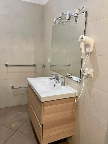 a bathroom with a sink and a mirror at Easy Milano - Rooms and Apartments Navigli in Milan