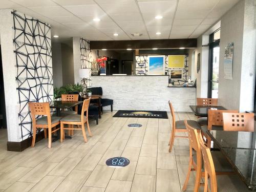 a restaurant with tables and chairs and a counter at Days Inn by Wyndham Asheville Downtown North in Asheville