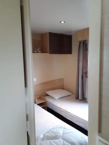a small room with two beds in a room at Stacaravan 4pers in Bredene met eigen tuintje 2449 in Bredene