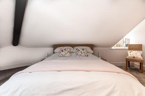 a white bed with two pillows in a bedroom at The Rooftop in Buxton