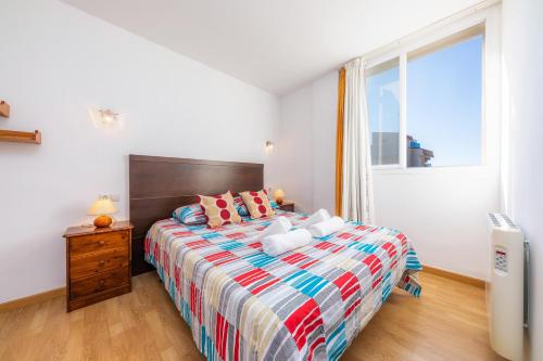 a bedroom with a large bed and a window at Casa Laura in Cala Ratjada