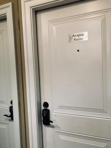a white door with a sign that reads actual suite at Suites at 249 in Culpeper