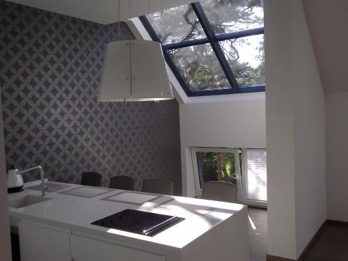 a kitchen with a sink and a window at Central Apartment Palanga in Palanga